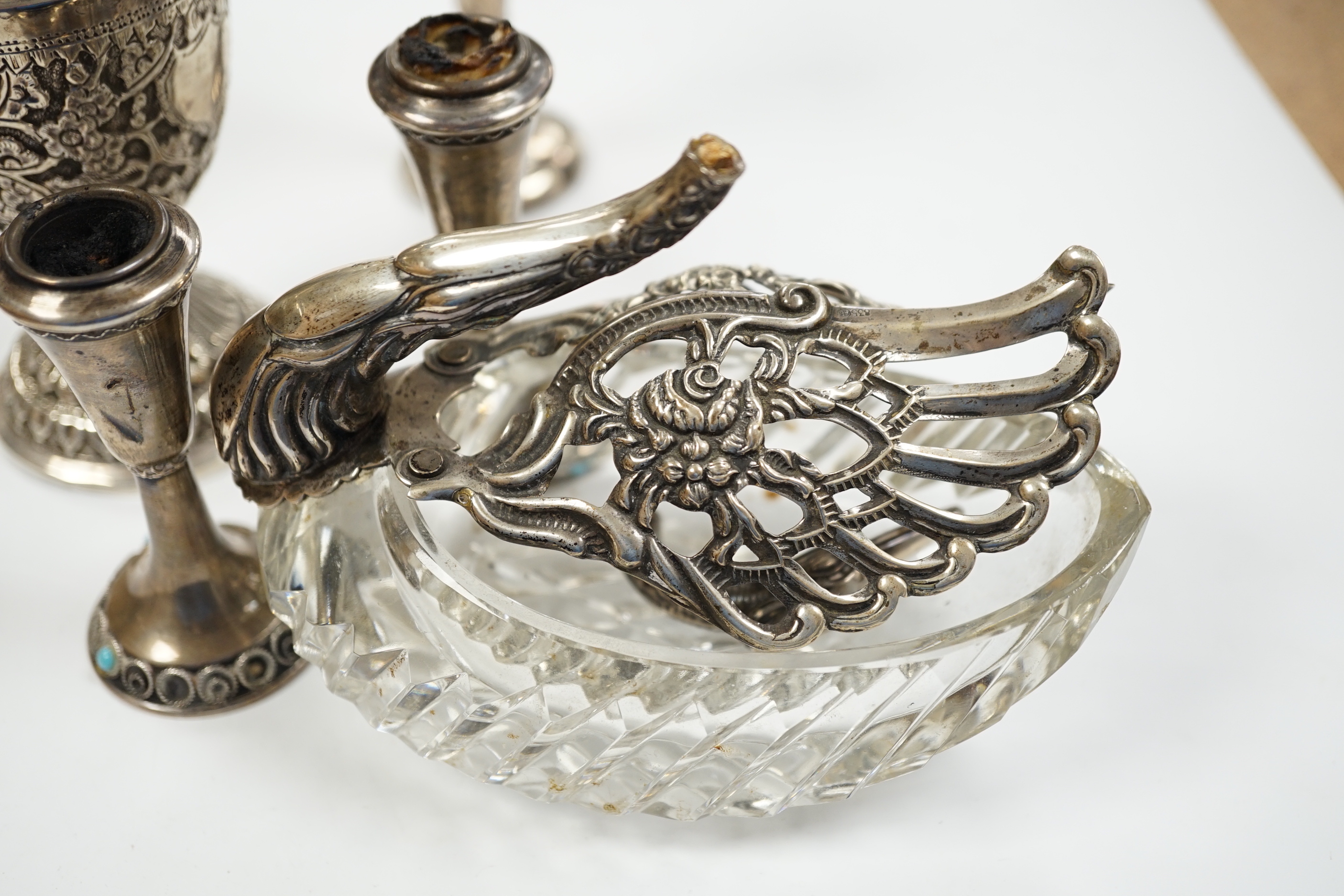 Two small white metal candlesticks, 8cm, an Indian vase, silver posy vase and a white metal mounted glass swan dish, a.f.